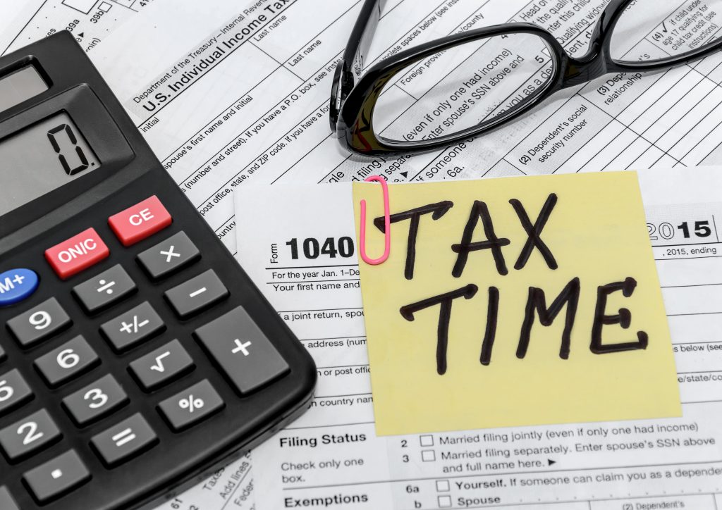 Tax form with calculator and glasses